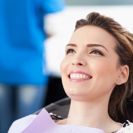 Woman smiling during Saturday dental appointment