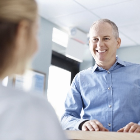 Man smiling durin concierge level dental experience