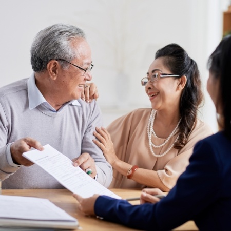 Dentistry patients discussing the cost of dental implants