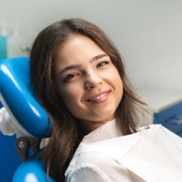 Closeup of patient smiling while relaxing in treatment chair