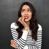 woman nervously biting her fingernails