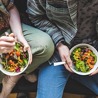 Closeup of man and woman eating healthy meal