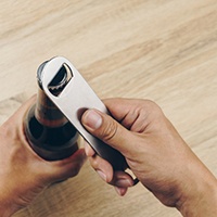 Patient using bottle cap opener