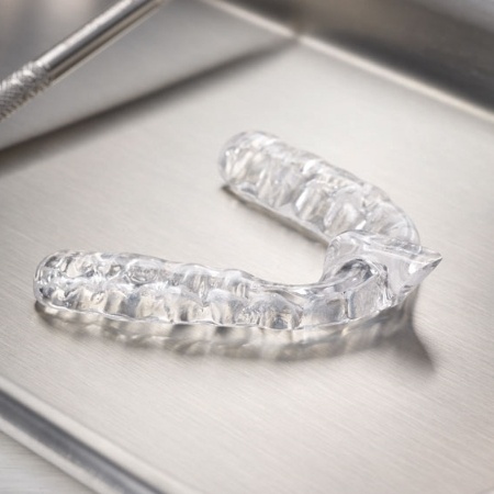 Clear nightguard for teeth grinding on metal tray