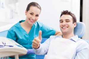 man giving thumbs up for the timing after implant placement after tooth extraction